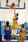 Colony senior Damien Fulp reaches to the basket to score two of his 10 points during the Alaska Association of Basketball Coaches Senior All-Star Games at Palmer High School Saturday. Fulp he