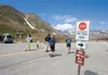 Visitors to Independence Mine State Historical Park in Hatcher Pass walk past the ‘pay fees’ sign in the lower parking lot. The road to the mine will only be open 9 a.m. to 9 p.m., Wednesdays