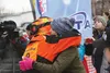 Tyson Johnson — half of Team 8 — hugs Alexis McCarty at the restart of the 2015 Iron Dog Pro Class Feb. 22 in Big Lake. HEATHER A. RESZ/Frontiersman