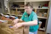 Senior volunteer Betty Anne Scheeler gets bags of groceries
ready at the Food Pantry of Wasilla Monday morning. (ROBERT
DeBERRY/Frontiersman