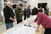 DOT Project Manager Kelly Summers [right] explains the Parks Highway Alternative Corridor project to members of the public. Jacob Mann/Frontiersman