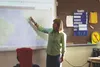 Houston Middle School math teacher Kelly Dau points to a map of Africa during a lesson Monday. Dau recently returned from South Africa, and was the subject of a rumor that alleged she had ins
