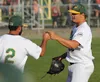 Mat-Su Miners assistant coach Joe Perez bumps a fist with pitcher Jordan Frederick during a 3-2 loss to the Peninsula Oilers Wednesday, Aug. 3, 2016, at Hermon Brothers Field in Palmer. Typic