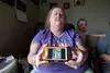 Laurie Luzader shows a picture on her phone of leaking pipes at the four-plex she rents in Wasilla. Luzader and her family are in a dispute with their landlord over the living conditions at t
