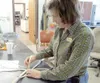 VICKI NAEGELE/For the Frontiersman Concentrating on making a
birch star at the UAF Birch Bark Workshop is Connie Harris of
Palmer, while in the background, Karen Mannix, a teacher at
Talkeetn