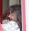 AMY MENEREY/Frontiersman Jennifer Wilson receives a hug from
Nycca Gonsalez at the dedication of Wilson's Habitat for Humanity
home. Gonsalez, who was a recipient of a Habitat home in 1998, w