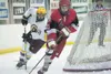 Wasilla forward Colton Fletcher moves the puck from behind the
net during the Warriors’ game against the Dimond Lynx. ROBERT DeBERRY/Frontiersman