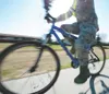An Airman rides his bicycle to work on Joint Base Elmendorf-Richardson, Alaska, May 10, 2014. Riding a bicycle is one of many physical activities available as part of National Physical Fitnes