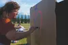 Sherry Carrington with Connect Palmer decorates the outside of her volunteers’ dwelling for Family Promise Mat-Su’s annual Cardboard City event at the Alaska State Fairgrounds in Palmer on Fr