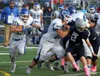 Palmer senior running back Larry Cutsforth follows Palmer senior lineman Lucas Santana as Santana moves Soldotna's Cody Quelland out of the running lane during a 21-0 loss to the Stars in the