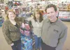 ROBERT DeBERRY/Frontiersman Sally Summers, left, and Alesia
Finch experienced first-hand an example of generosity when Wasilla
Radio Shack owner Jim White, right, gave enough remote-controlle