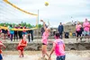 A member of the Ace Eaters hits the ball over the net during the beginning of the Big Lake Lions mud volleyball tournament. Katie Stark/For the Frontiersman