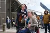Sara Kveum speaks to the crowd rallying in front of the Alaska State Capitol, alongside Nikki Bass, both members of the Key Coalition of Alaska advocating for disability rights on March 19, 2