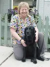 Wasilla veterinarian Joanne Rehn and Shadow, one of her nine
four-legged family members, outside her clinic. Photo by AMY
MENEREY/Frontiersman.