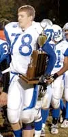 Palmer lineman Nick Pilch holds on to the Mayor's Cup Trophy
following Palmer's 42-0 victory in the 25th annual Potato Bowl
Friday. With the win, the Moose earn the right to keep the coveted
