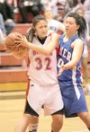 ROBERT DeBERRY/Frontiersman Warrior forward Cleste Colegrove
protects the ball from Palmer's Ashley Swetzof during wednesday
game at Wasilla High School. Colegrove scored the winning shot to
