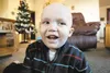 Seth Bellamy, 2, laughs for the camera during a recent visit at his Wasilla home. Bellamy has been diagnosed with cancer and the family is holding a fundraiser Saturday at the American Legion