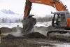 An Alaska Demolition backhoe uncovers buried debris Tuesday, releasing steam from the site. The Alaska Department of Environmental Conservation says it's satisfied the site is releasing steam