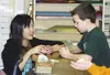 Yurie Suzuki of Saroma, Japan helps fifth-grader Matt Homola
with an origami ball that expands when you blow into it. Suzuki was
one of five high school girls from Saroma to visit Palmer. The