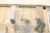 ROBERT DeBERRY/Frontiersman From left, Alaska Glass and Door
employees Al Ramos, Jeremiah Glenn and Wayne Glenn install new
windows in the storefront at the corner of South Alaska Street and
