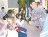 SHARON G. McBRIDE/Frontiersman Spc. Trey Shockey, with
Headquarters and Headquarters Company, 3rd Battalion, 297th
Infantry Brigade, Alaska National Guard, talks with third- and
fourth-grader