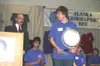 J.J. HARRIER/ Frontiersman Thomas Long, an eighth-grader from
Kodiak Middle School, accepts his prizes after winning the 2008
Alaska Geographic Bee at the Egan Convention Center in Anchorage
