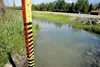 A measuring stick stands at the Maud Road extension where flood waters from the Matanuska River washed the road out last year and caused flooding to several properties in the Butte area. ROBE