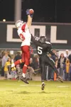 Wasilla junior Tim Orr reaches to make the catch as Colony
senior D.J. Mouton tries to knock away the ball during the fourth
quarter of the Warriors’ 28-21 overtime win over the Knights. Orr

