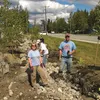 Sustainable Design Group co-owner Eric Morey and Laura Eldred with the Departments of Environmental Conservation smile for the camera during construction of a rain garden for Mat-Su Senior Se