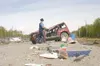 An Alaska State Trooper looks over the aftermath of a single car
rollover near Mile 5.7 of Knik-Goose Bay Road. The occupant of the
car, a 64-year old male whose name was unavailable, was con