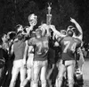 Warriors gather on the field to celebrate their 19-17 victory
and grasp the Mayor's Cup trophy given to the winner of the Potato
Bowl. Wasilla will keep the trophy until next year's winner is