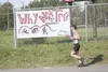 A competitor passes a sign advertising the Why Not Tri Wasilla triathlon in this Frontiersman file photo. The 2017 event is set for Saturday at Wasilla High School. Frontiersman file photo
