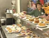 GREG JOHNSON/Frontiersman Laurel Flynn reaches for a piece of
pie from a large selection of homemade treats at Thursday’s 17th
annual Christmas Day Dinner at Wasilla High School.