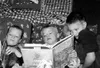 First-graders Dylan Schutt, Doug Tanner and Brett Keene cozy up
with good books during the classroom readathon. Photo courtesy
Tanaina Elementary.