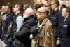 Alaska veterans, servicemembers, friends and family stand for the national anthem at a Veterans Day ceremony at the Alaska National Guard Armory on Joint Base Elmendorf-Richardson, Nov. 11, 2