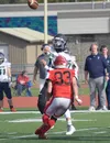 Redington's Wayde Bowman passes over Kenai Central's Reagan Graves on Saturday, Sept. 11, 2021, at Kenai Central High School in Kenai, Alaska. Jeff Helminiak/Peninsula Clarion