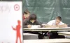 ROBERT DeBERRY/Frontiersman Palmer residents Andrew
Christiansen, 18, left, and Jesse Romero, 17, fill out applications
at the Target job fair Saturday at the Wasilla Mulit-Use Sports
Complex