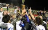 Palmer High head coach Rod Christiansen lifts the Mayor's Cup following a victory over Wasilla in the 2016 Potato Bowl. Christiansen, who recently set the record for career wins by a head foo