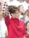 PAUL VERNON/Associated Press Republican vice presidential
candidate Gov. Sarah Palin holds up a buckeye necklace before a
campaign rally at Capital Universtiy in Bexley, Ohio, on
Monday. PAUL