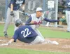 Road Warriors pitcher Kyle Bovy covers home plate during the
bottom of the fifth inning Friday at McManus Field in Wasilla.
ROBERT DeBERRY/Frontiersman
