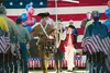 Erik Swanson with brothers Matthew and Gregory stand at attention for the fife and drum flag ceremony during the Conservative Patriots Group’s “Liberty for We the People Concert and Rally” at