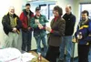 Incoming Mat-Su Homebuilders Association president Gary Smith
accepts a plaque from Marianne Shlegelmilch, manager of the Blood
Bank of Alaska Mat-Su Center. From left are Thom Antonovich, To