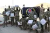 U.S. Soldiers with the 28th Expeditionary Combat Aviation Brigade pose for a photo after receiving care packages from Lily Palfrey, daughter of 1st Sgt. Frank Palfrey who is the senior enlist