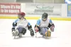 ROBERT DeBERRY/Frontiersman Two members of the Alaska Avalanche
sled hockey team skate across the ice of the Curtis C. Menard II
Memorial Ice Arena before a scrimmage during the intermission 