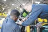 Airman 1st Class James Walton and Senior Airmen Brian Baker, both vehicular equipment maintainers at the 673d Logistics Readiness Squadron Heavy Equipment Shop, work on an engine installation