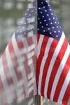 ROBERT DeBERRY/Frontiersman An American flag is reflected in the
polished stone of the Veterans’ Wall of Honor in Wasilla.