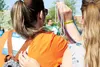 Anna Dunks and daughter Mariah Miller hold up beads during the Honor Bead Ceremony at the Mat-Su Valley’s first ‘Out of the Darkness’ walk Saturday in Palmer. HEATHER A. RESZ/Frontiersman