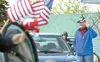 ROBERT DeBERRY/Frontiersman Wasilla resident Tom Stearns waves a
flag as the Memorial Day procession begins to walk from the Wasilla
Post Office to Aurora Cemetery Monday morning.
