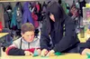 Palmer High School student Chihiro Hatayama teaches a student at Sherrod Elementary School how to fold paper cranes during a presentation at the school Sept. 17. Hatayama is a student from Sa