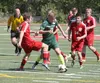 Colony's Chris Olsen tries to drive through a group of Kenai Kardinals during a 3-2 overtime win over Kenai May 23 at the NLC tournament in Wasilla. Jeremiah Bartz
